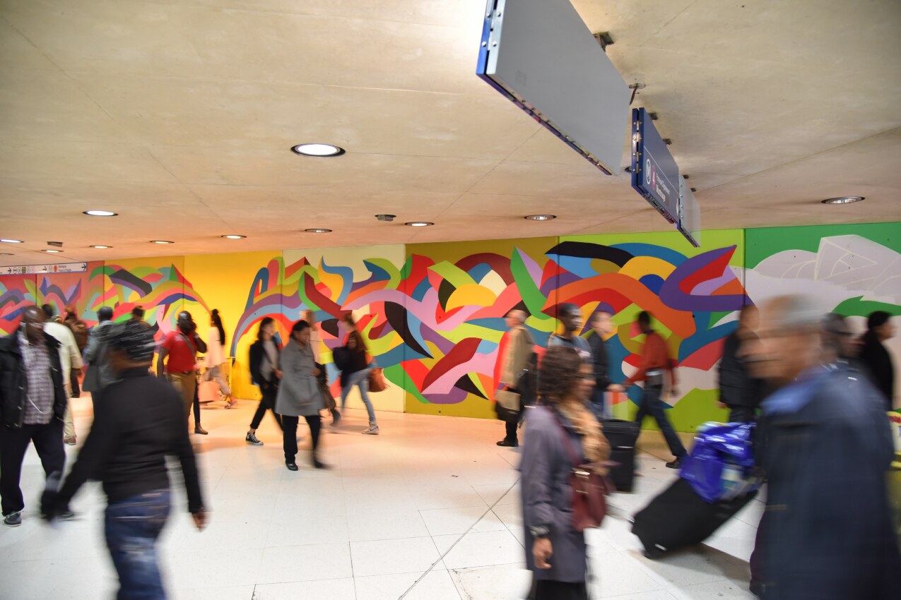Commuters moving past Kool Koor’s 35 metre mural at Gare du Nord